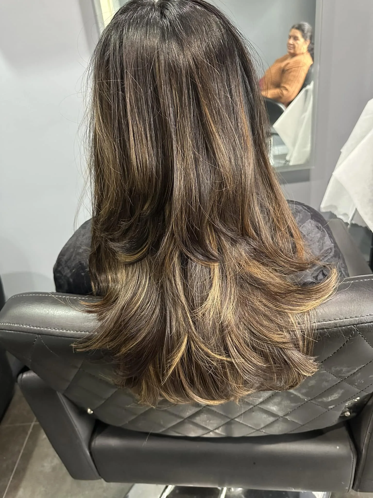 Hair styling result showing the salon chair and mirror — Kaur's Beauty